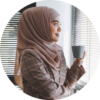 young-asian-muslim-business-woman-in-smart-casual-wear-standing-beside-the-glass-wall.png